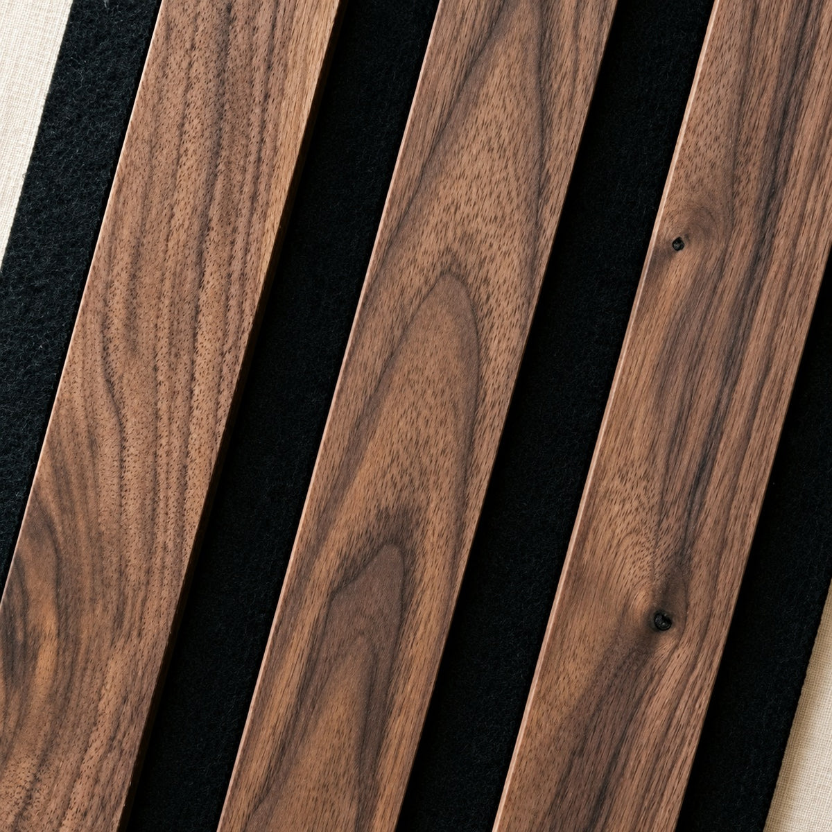 Close-up of Solid American Walnut slats on black felt, showing the walnut grain