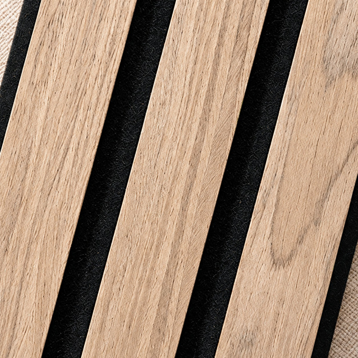 Close-up of Ultralight Walnut slats on black felt, showing the veneer grain